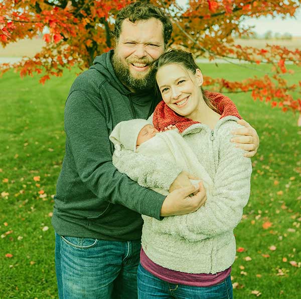 Image of Charles Pol and his wife Beth along with their baby Abigail Pol